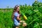 Retro beautiful girl showing zucchini. pretty kid on farm. beauty of summer nature. little girl on farming garden with