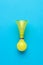 Retro bicycle horn in yellow on a blue background. Flat lay