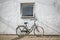 Retro bicycle on roadside with vintage concrete wall background