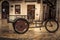 Retro bicycle on vintage europe medieval plaza with stone pavers in overcast day during raining autumn season in old European city