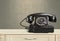 Retro black telephone on background