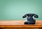 Retro black telephone on wood table