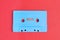 Retro blue audio cassette tape on red background