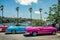 retro bright cabriolet cars on embankment in old Havana.