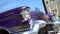 Retro Cadillac on background of sky. Actio. Luxurious retro Cadillac in purple color and resplendent appearance on