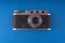 Retro camera in a flat style. Vintage camera on a colored background. Old camera with strap. Isolated antique Camera. Hung retro c