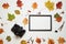 Retro camera and wooden photo frame with autumn fall leaves. Flay lay, top view. Copy space
