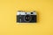 retro camera on the yellow background. Stylish background for a photo enthusiast. Flat lay