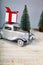 retro car carries gifts for Christmas