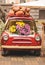 Retro car decorated with pumpkins and flowers. Concept autumn decor cafe