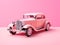 Retro car parked on pink background