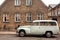 Retro car Volvo past brick house in traditional scandinavic style, Copenhagen of Denmark. Old auto parked