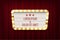 Retro cinema announcement board with bulb frame on red curtains background. Vector design element.