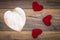 Retro classic Valentine`s Day cad, large white painted wooden hart, isolated, 3 red cuddle harts, on vintage oak panels - top view