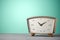 Retro classic wooden alarm clock vintage color background