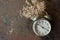 Retro Clock and white flower lying on rusted table