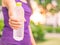 Retro close-up plastic water bottle in woman hand after jogging