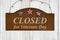 Retro closed for Veterans Day rusted sign on weathered wood