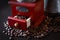 Retro coffee grinder with drawer pulled out and coffee beans on dark background, close-up