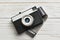 Retro compact photo camera and film on white