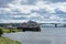 Retro cruise ship in the river port of the city of Kostroma. A golden ring. The bridge over the Volga River. Green grass. sky