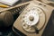 Retro disk telephone on a table with a pencil and a phonebook