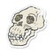 retro distressed sticker of a cartoon ancient skull