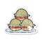 Retro distressed sticker of a cartoon plate of burgers
