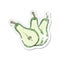 Retro distressed sticker of a cartoon sliced pear