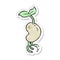 retro distressed sticker of a cartoon sprouting seed