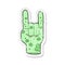 retro distressed sticker of a cartoon zombie hand making horn sign