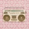 Retro eighties radio cassette player in front of vintage wallpaper