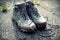 Retro Faded Photo Of Dirty Walking Boots on Sidewalk