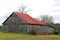 Retro farm barn red roof empty field