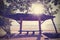 Retro filtered photo of a seaside bench at sunset