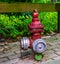 Retro fire prevention system, Red fire hydrant with multiple hose fittings, outdoor safety
