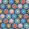 Retro florals seamless vector background. 1960s, 1970s flower design. Red, blue, and yellow doodle flowers on a blue background.