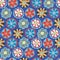 Retro flower seamless vector background. 1960s, 1970s floral design. Red, blue, and yellow doodle flowers on a blue background.