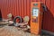 Retro gas pump and rusted chairs