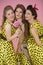 Retro girls. Three beautiful women in yellow dresses