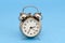 Retro grunge rusty alarm clock blue background