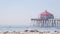 Retro huntington pier, surfing in ocean waves and beach, California coast, USA.