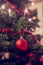 Retro image of Christmas tree decorated with traditional ornaments