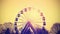Retro instagram toned silhouette of ferris wheel.