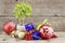 Retro look Christmas decorations with red ball,green ball,red ribbon,bell,samll tree on white pot, and artificial flower. aged and