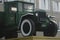 Retro lorry truck. Green color, down side. Body, silver exhaust pipe, car wheel