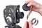 Retro mechanical movie camera and film strip in hands operator