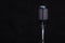 Retro metal microphone isolated on a dark background