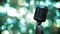 Retro metallic microphone against spots of light against green background