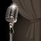 Retro microphone on the curtain background in dark vintage color